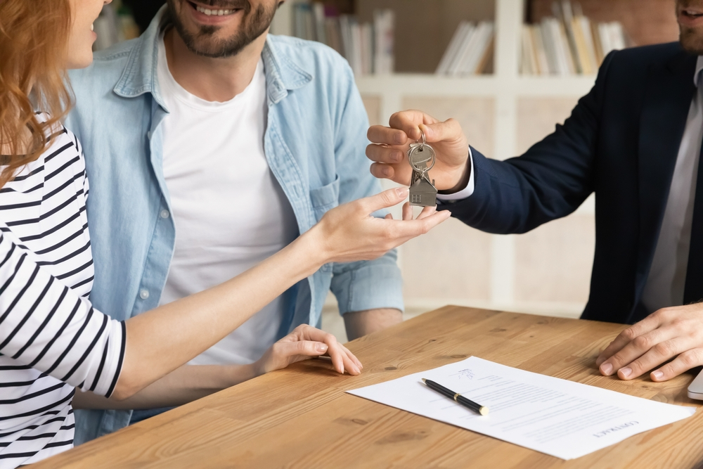 Cropped close up view of happy couple receiving keys from their new owned business. Business for sale in louisiana