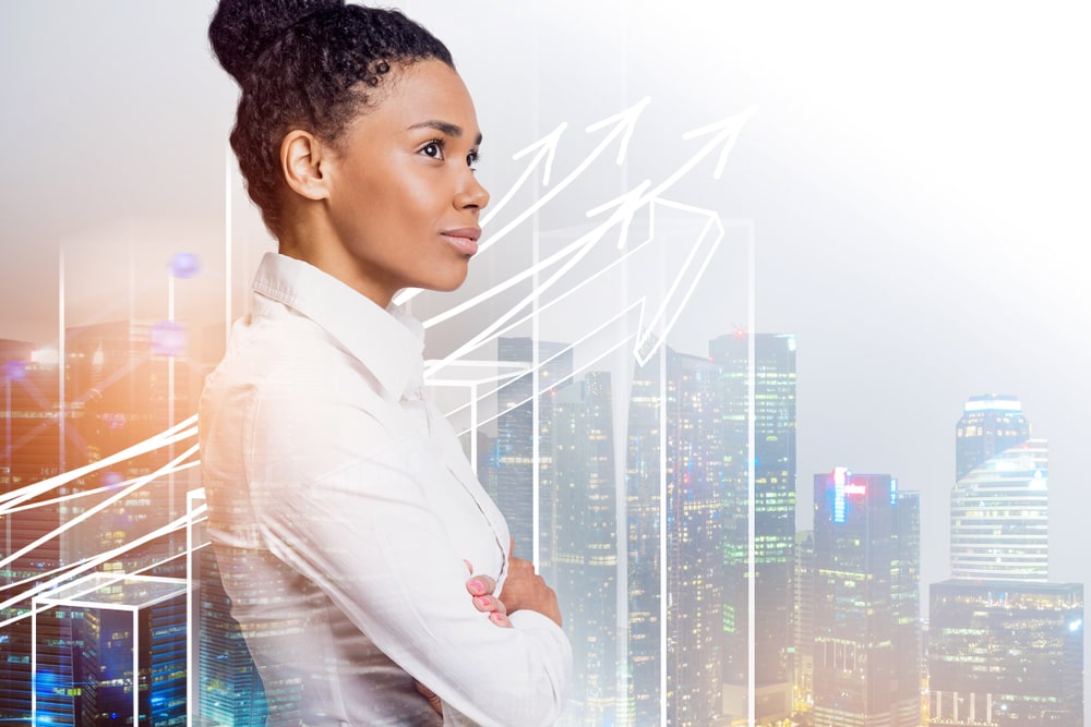  Side view of confident young businesswoman standing with crossed arms - business broker in New Orleans, louisiana