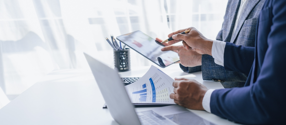 A Business broker valuating a business with a CEO holding a tablet - business for sale in lousiana